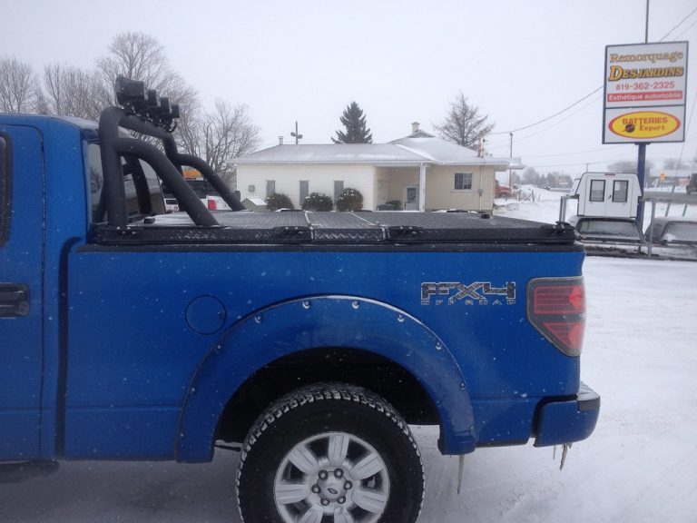 A hard tonneau cover installed on a pickup truck bed, providing a flat locking surface over the cargo area