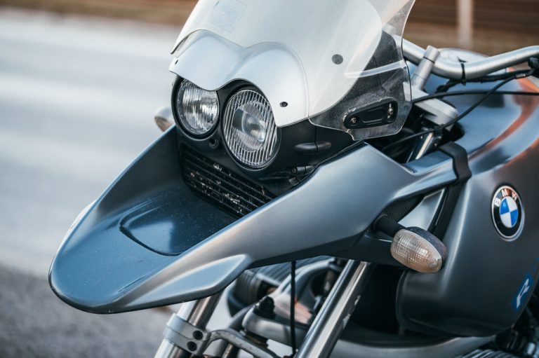 A close-up view of a round motorcycle headlight, a common application for H4 dual-filament bulbs