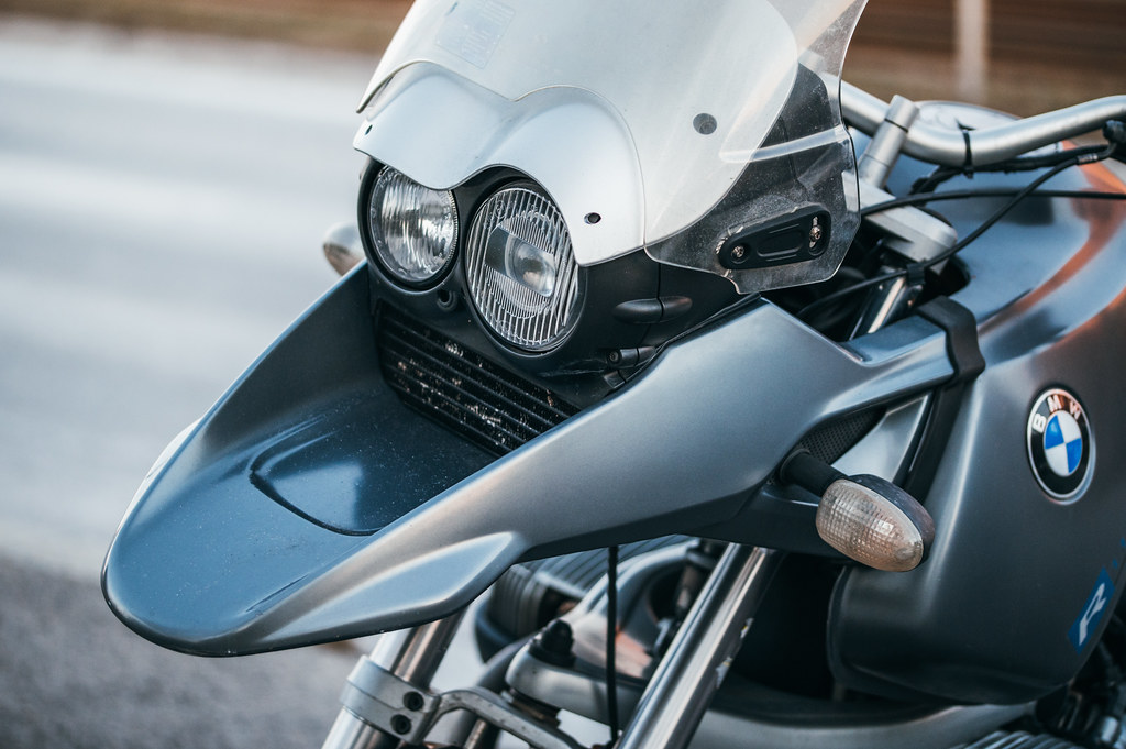 A close-up view of a round motorcycle headlight, a common application for H4 dual-filament bulbs
