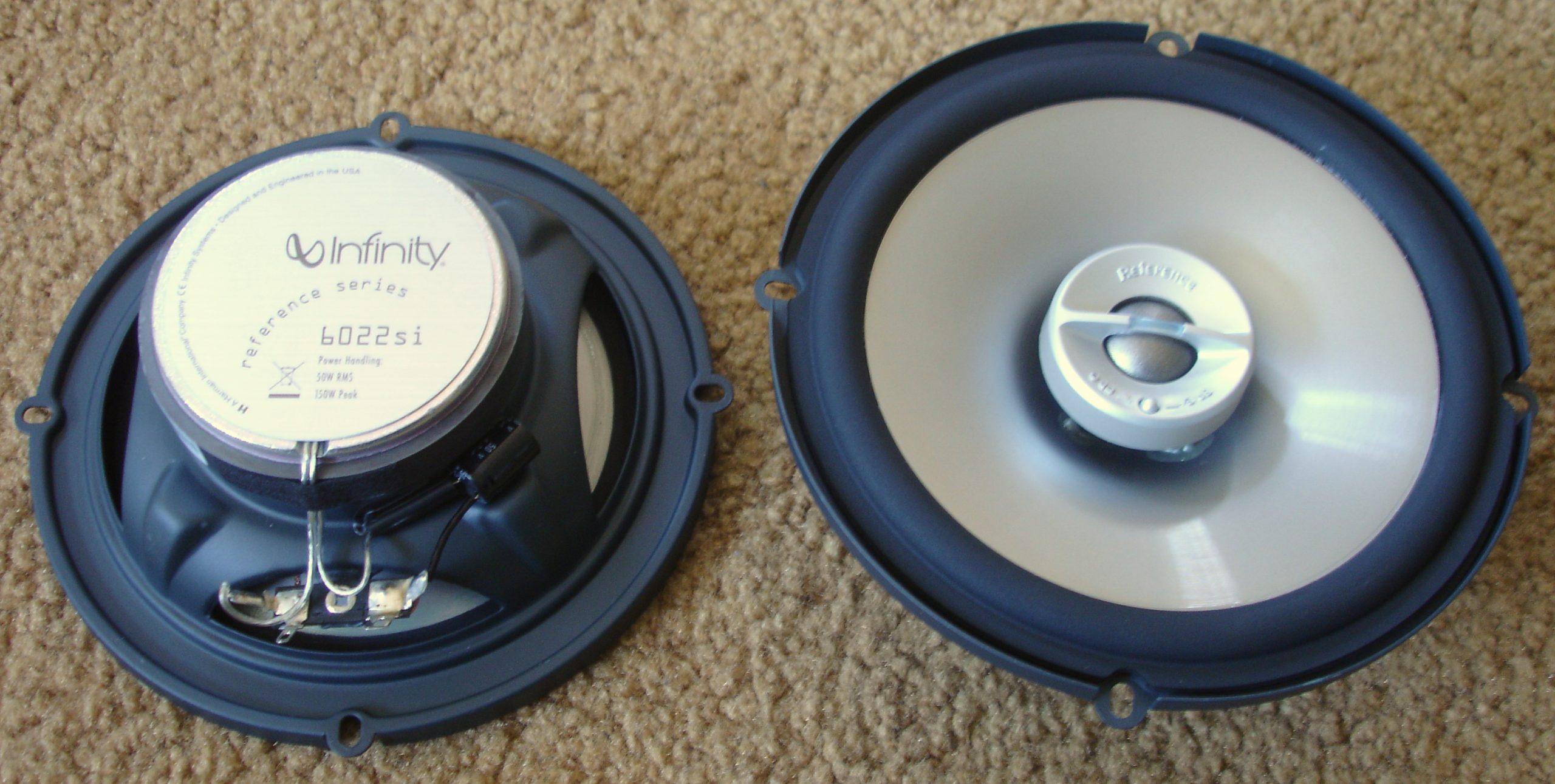 Top view of a car speaker showing the tweeter and woofer components.