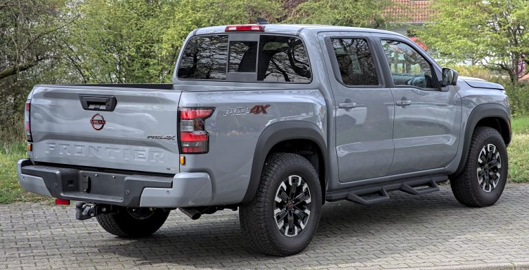 A silver Nissan Frontier D41 Pro-4X pickup truck showing its factory LED headlight and front grille design.